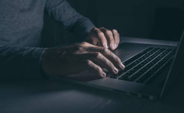istock Hands typing on laptop keyboard. Man working on computer. Dark mood. Technology, business concept 1466633488