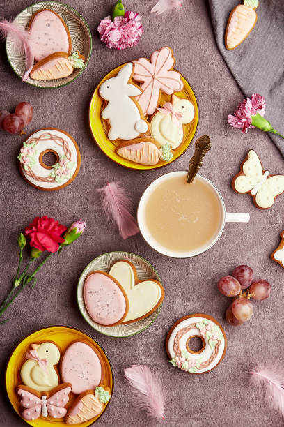istock Aesthetic happy Easter background, coffee time top view. Decorated glazed cookies, coffee, feathers flat lay. Spring background 1466634311