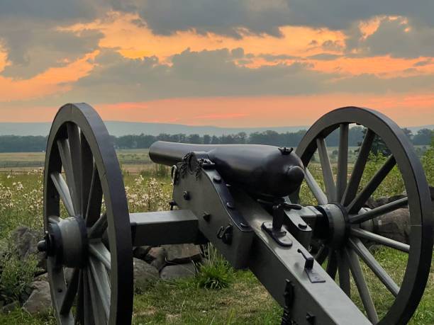 istock Cannon on wheels pointing to the field on the sunset 1466636909