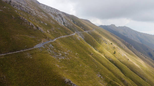 istock Aerial view of an empty narrow mountainside road 1466637340