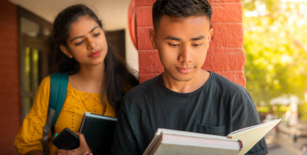 istock Multiethnic college student friends studying together at campus. 1466637568