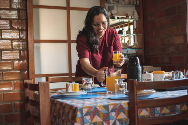 istock Woman serving orange juice 1466638121