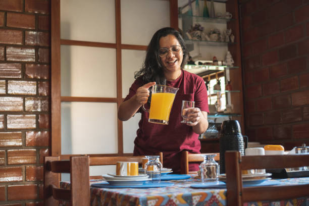 istock Woman serving orange juice 1466638152
