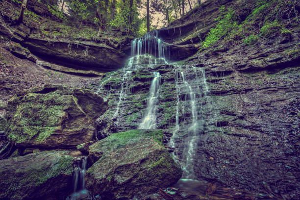 istock Beautiful view of the small waterfall flowing over the rocks 1466638266