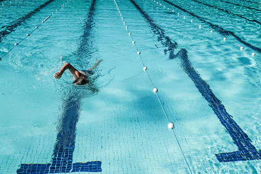 A shot of a woman swimming in a professional swimming pool