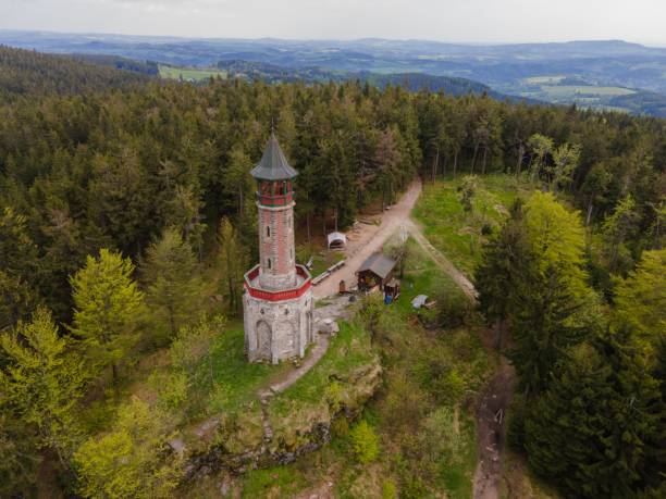 istock Tower and a building in a summer forest 1466639207