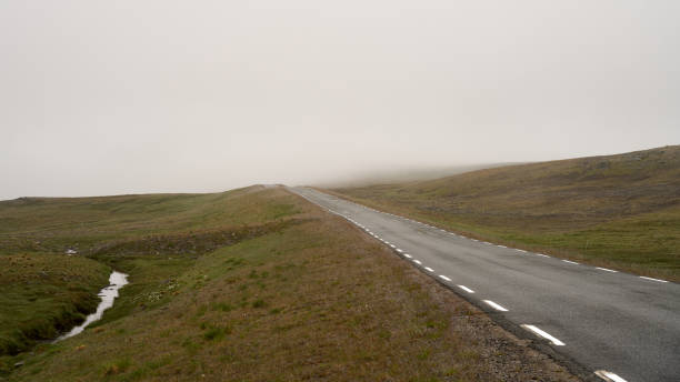 istock Empty road in Nordkapp, Norway under a cloudy sky 1466640516
