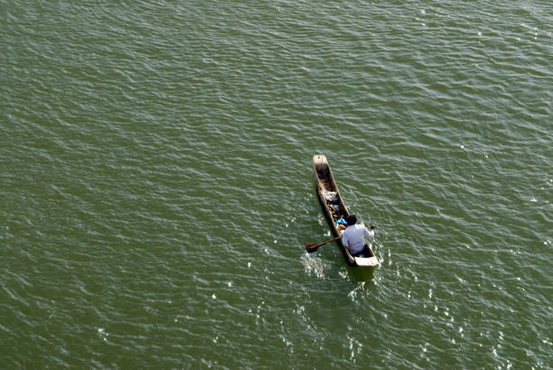 Aerial view of a  very small boat in Narmada River at Omkareshwar district Khandva Madhya Pradesh