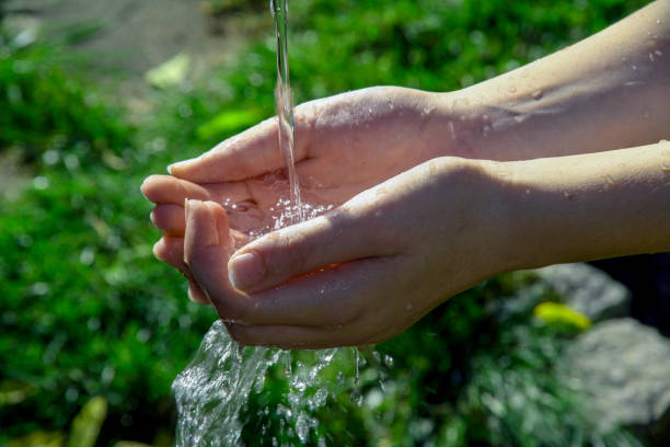 istock View of pure clean water falling on a person's hands 1466640649