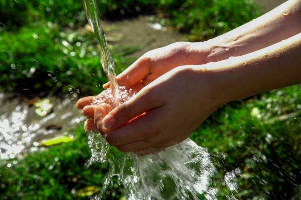 istock View of pure clean water falling on a person's hands 1466640659