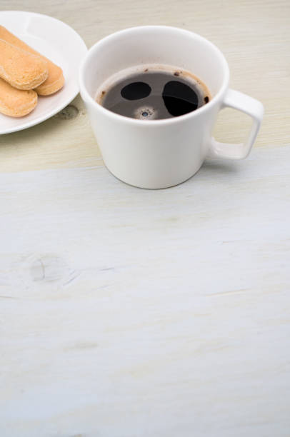istock cup of black coffee and light crisp biscuits  in a plate 1466643002