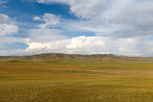 Scenic view of green landscape against cloudy sky, Murun, Mongolia.