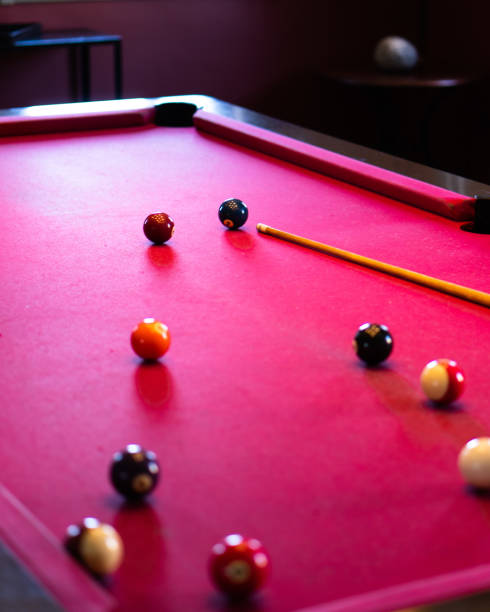 istock Vertical shot of a red billiard table with balls and stick 1466643746