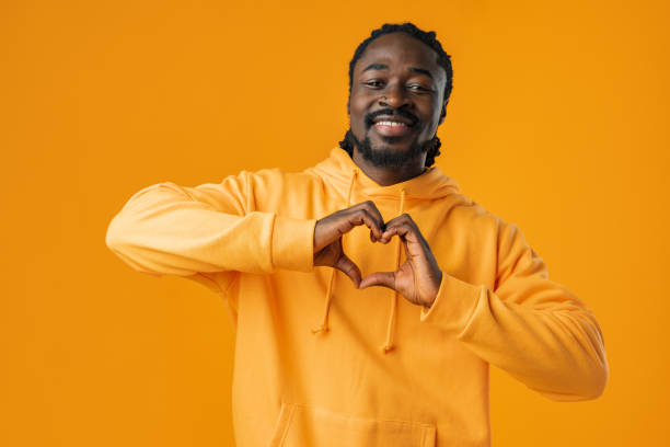 istock Young african man with beard wearing casual sweatshirt doing heart symbol shape with hands 1466644044