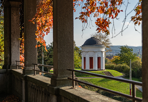 Beautiful garden in autumn colors in Kassel, the gateway to the city, with a little temple, Germany