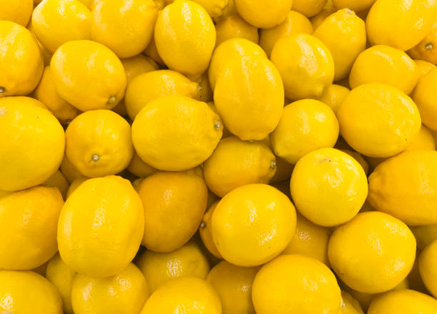 istock Ripe whole yellow lemon citrus fruit texture background. Fresh lemon fruit pattern. 1466644293