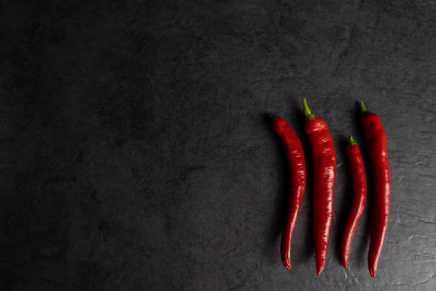 istock Red fresh chili peppers on a black background 1466644361