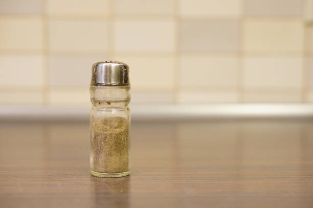 A black pepper shaker on the kitchen table; background with a copy spa
