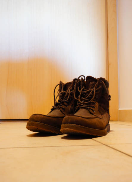 istock Vertical shot of old brown boots on the floor 1466646148