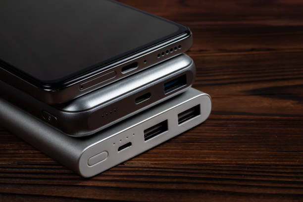 istock Two powerbank and smartphone on wooden table 1466647117