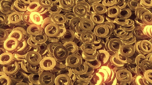 Huge pile of gleaming scattered round golden nuts fasteners