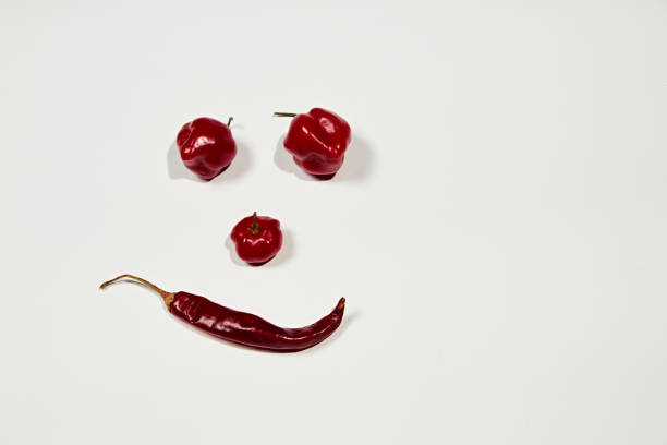 istock View face-shaped chili peppers on white background 1466648797