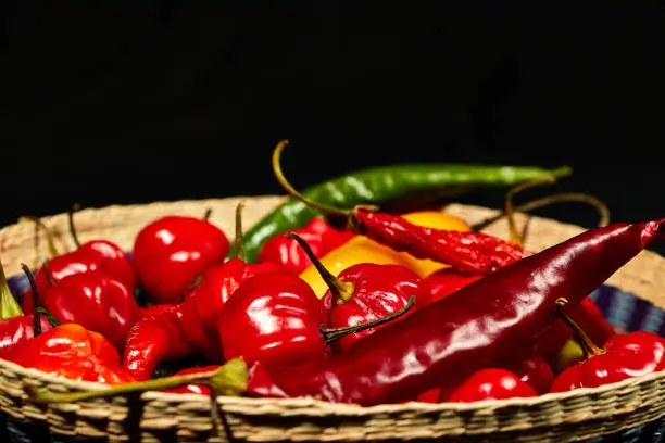Photo of Closeup of Red chilli peppers on black background