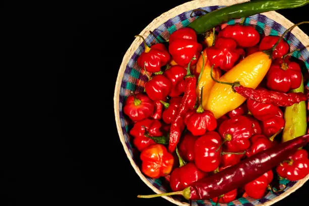 Photo of Top view of Red chilli peppers on black background