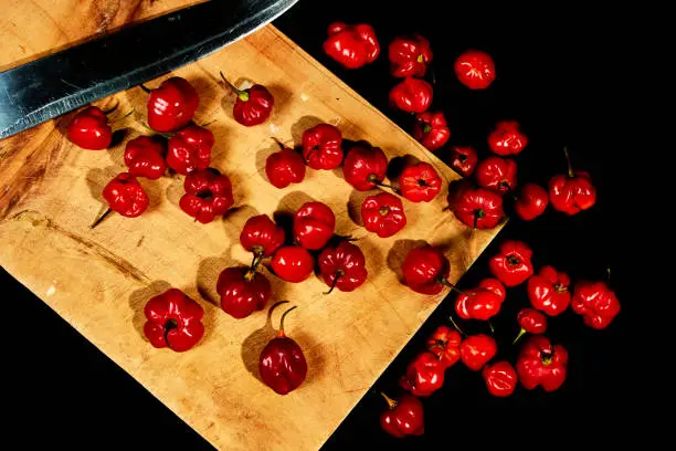 Photo of Top view of chile habanero tout on a cut table and black background