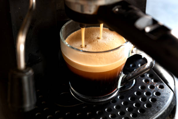 istock High angle closeup of a mug and a coffee machine in the process 1466649321