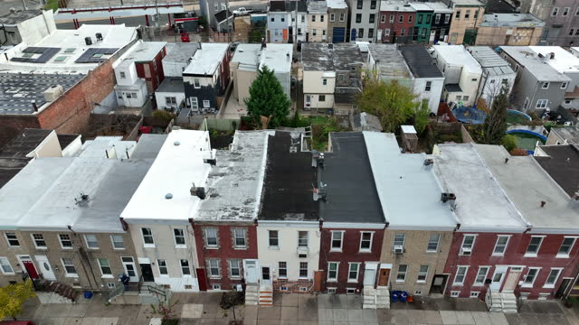 Aerial of row homes, residential housing neighborhood in downtown urban city in USA. American lifestyle establishing shot.