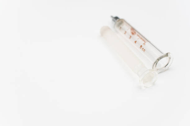 istock isolated sterilized glass injection syringe on  a white paper background 1466650089