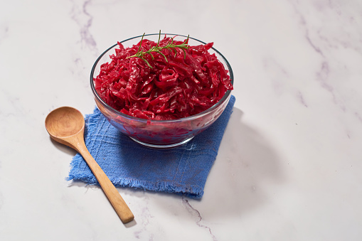 Home-fermented red cabbage sauerkraut in a glass bowl. For vegetarian food