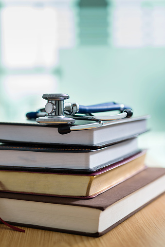Medical stethoscope on top of books.