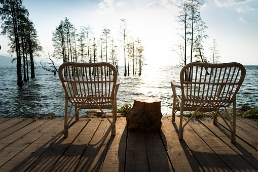 Wooden chairs on the lakeside.