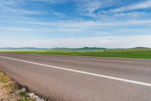 istock Empty asphalt road and green field 1466654054