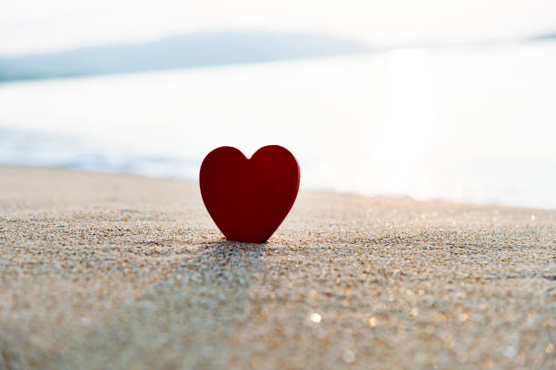 istock Single red heart shape on the beach 1466654260