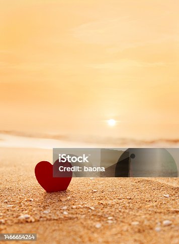 istock Red heart shape on the beach at sunset 1466654264