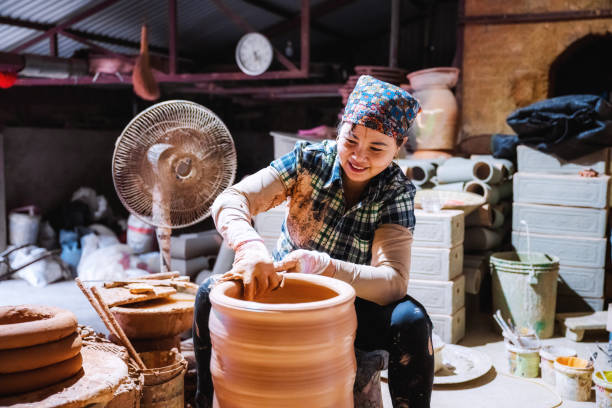 istock woman making jar at pottery wheel 1466654472