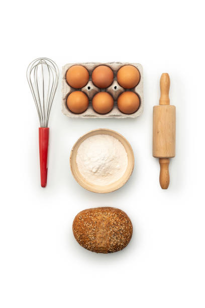 Baking ingredients and kitchen utensils on white background