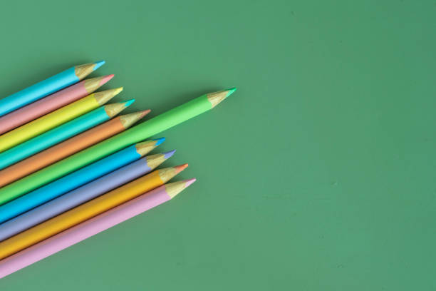 istock Pastel colored pencils, top view on green background, illustration concept, education and back to school 1466668110