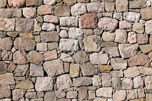 ashlar aligned and stacked to form a stone wall