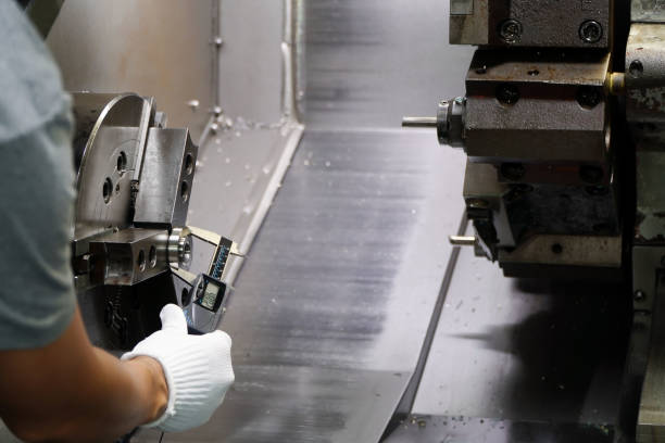 istock Quality control manufacturing.Hands of an engineer measures a metal part with a digital vernier caliper 1466668949