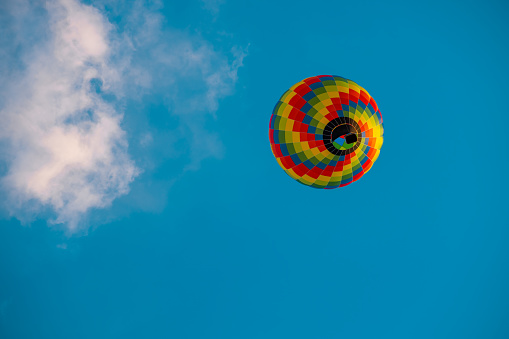 colorful hot air balloon landing with 6 spectators in foreground, , Canon 1Ds Mk II