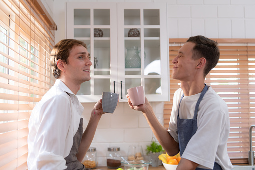 LGBT Young couple taking a break for tea and coffee After cooking for a while