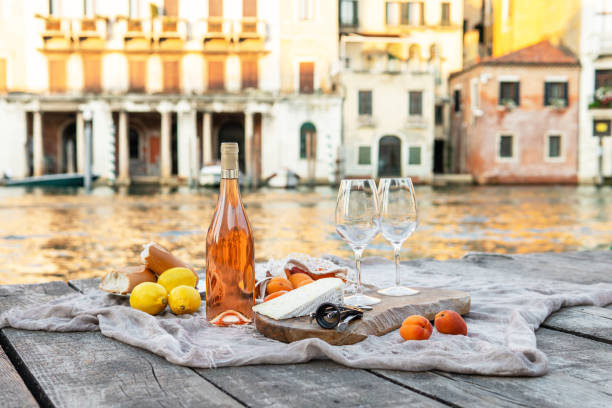 Rose wine, fruits and snacks on the wooden pier during picturesque picnic on the wooden dock Rose wine, fruits and snacks on the wooden pier during picturesque picnic on the wooden gondola dock wine italian culture wine bottle bottle stock pictures, royalty-free photos & images