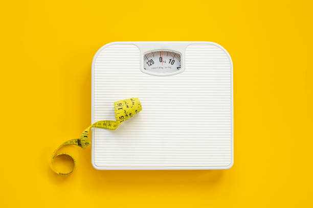 istock Weight scale and tape measure top view. Weight control concept 1466681795
