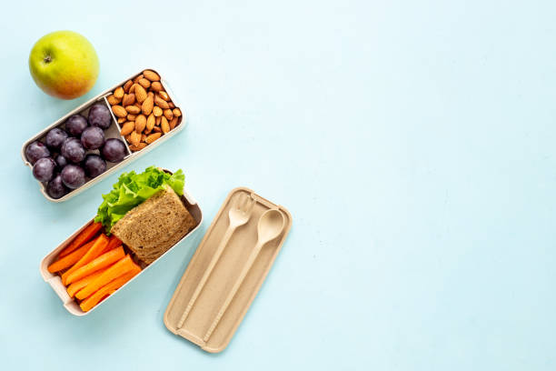 Luch box with sandwiches and bamboo cutlery stock photo