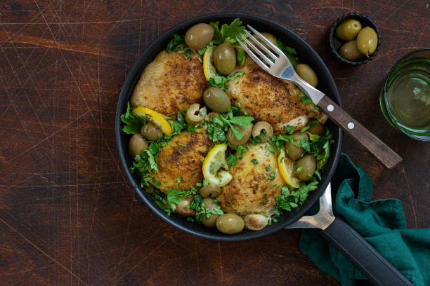 istock roasted chicken thigh with lemon and olives on pan 1466685133