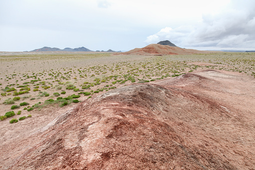 Scenic view of Gobi desert against cloudy sky, Gobi Gurvansaikhan National Park, Mongolia.